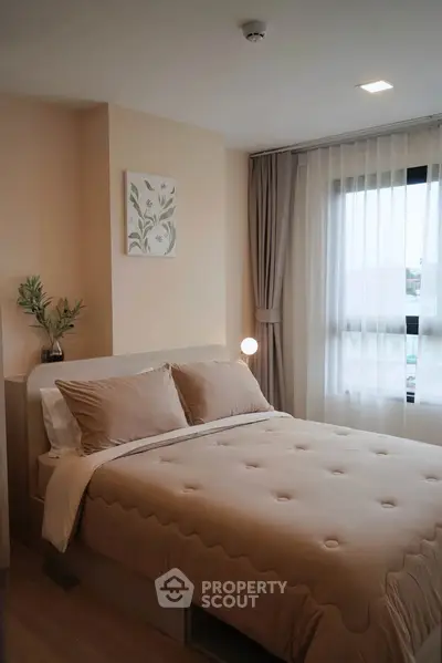 Cozy and modern bedroom with natural light and elegant decor, perfect for relaxation and comfort.