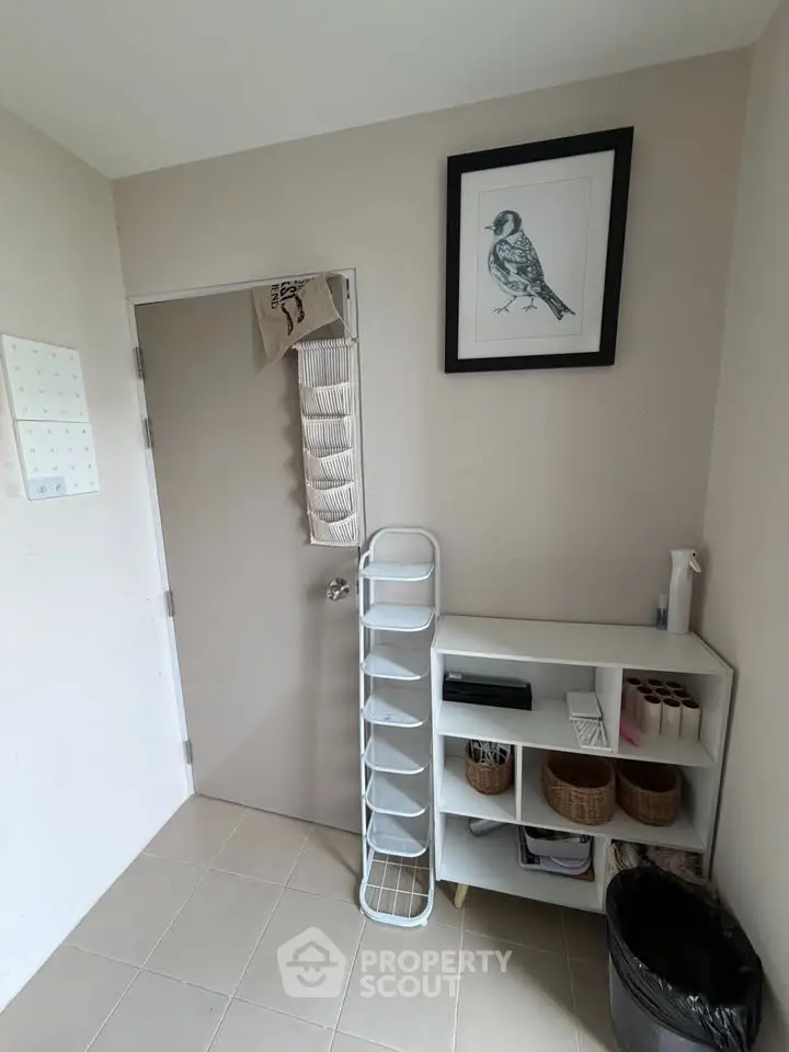 Cozy storage area with wall art and organized shelving in a modern home.