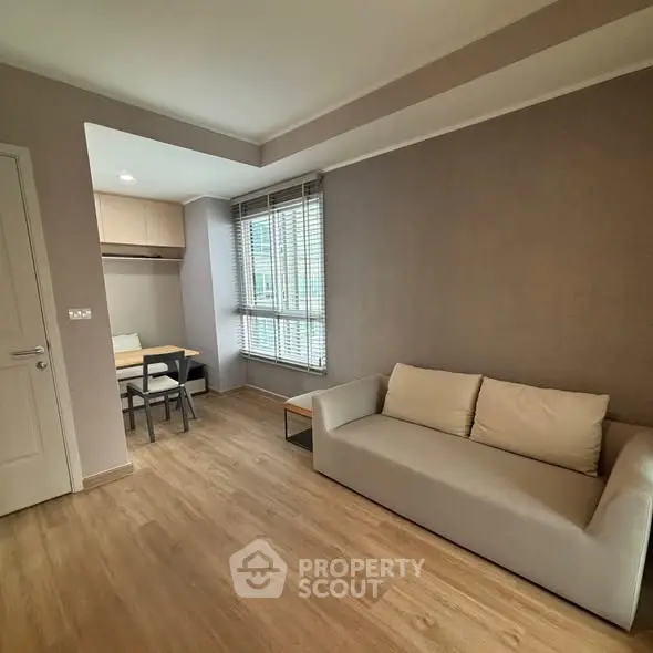 Modern living room with cozy sofa and dining area in a stylish apartment.