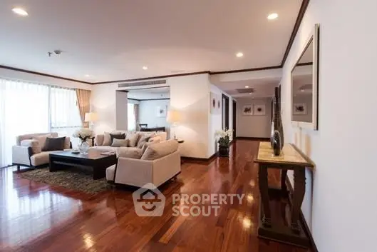 Spacious and elegant living room with hardwood floors and modern decor