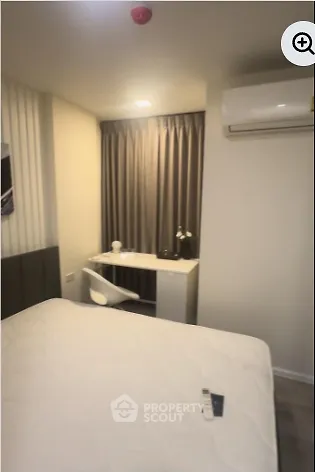 Cozy bedroom with modern decor and air conditioning unit, ideal for comfort and relaxation.
