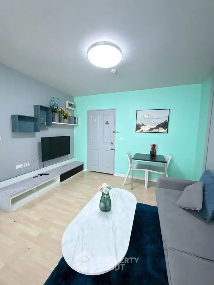Modern living room with stylish decor, featuring a sleek TV unit and cozy seating area.