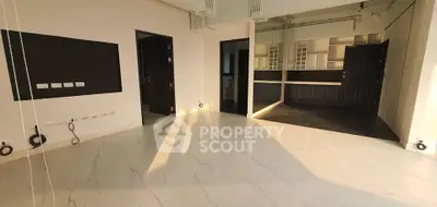 Spacious modern living room with open layout and elegant flooring, perfect for contemporary living.