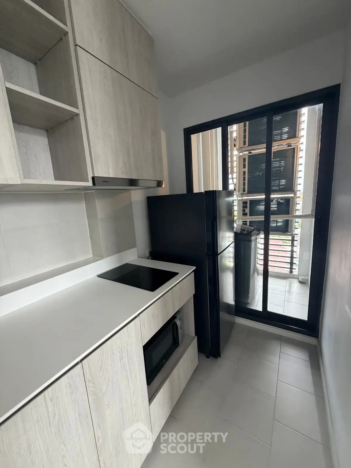Modern kitchen with sleek cabinetry and large window for natural light
