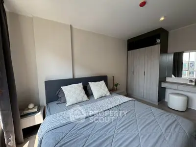 Modern bedroom with stylish decor and ample natural light, featuring a comfortable bed and sleek wardrobe.