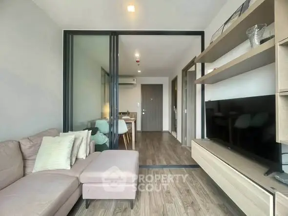 Modern living room with sleek furniture and open layout in a stylish apartment.