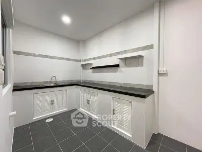 Modern kitchen with sleek black countertops and ample storage space