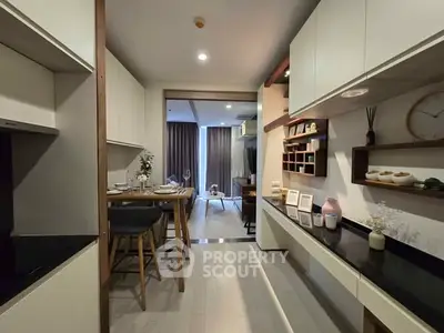 Modern kitchen with open layout and stylish dining area in a contemporary apartment.
