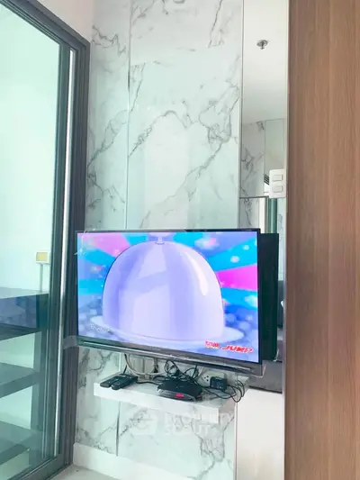 Modern living room with wall-mounted TV and marble accent wall