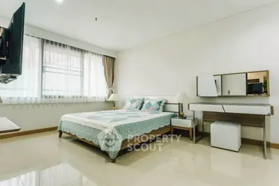 Spacious modern bedroom with elegant decor and natural light