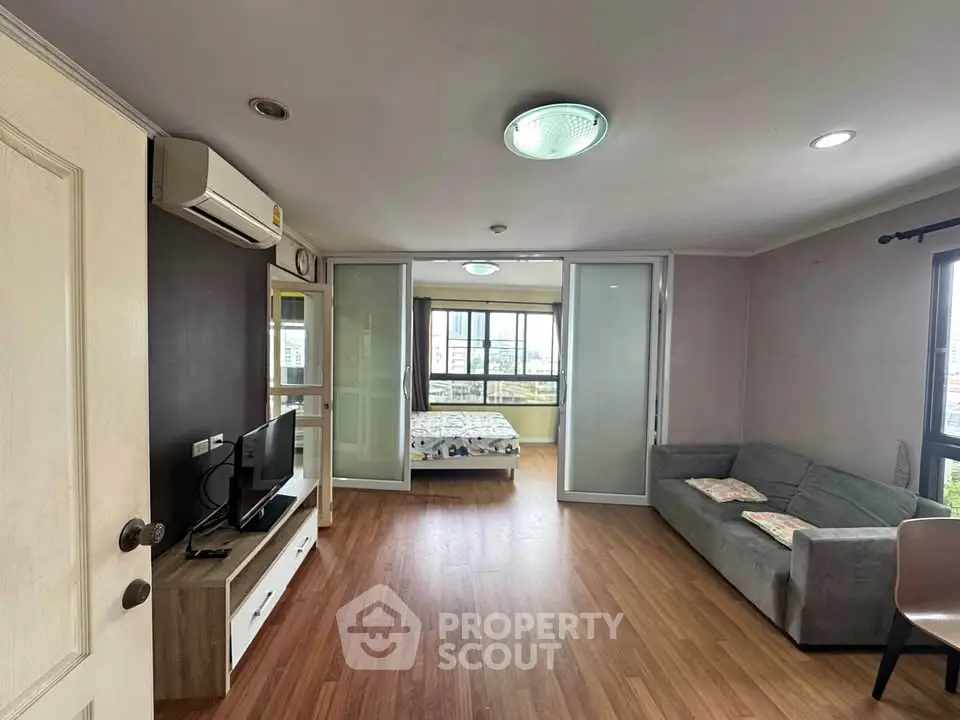 Spacious living room with modern decor and large windows offering natural light.