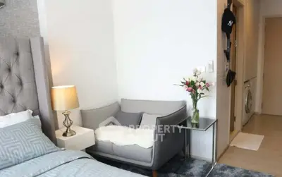 Chic modern bedroom with cozy seating area and stylish decor