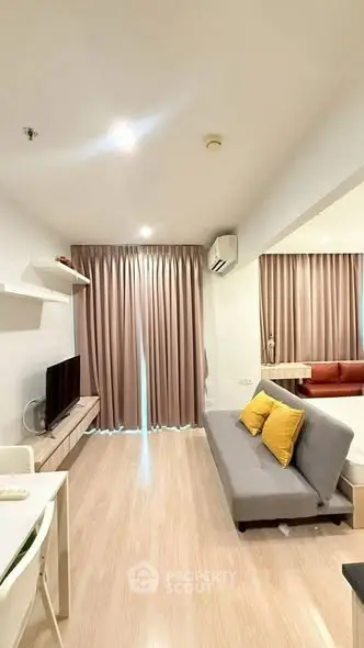 Modern living room with cozy sofa and stylish decor in a bright apartment.