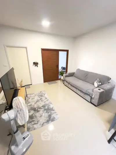 Cozy living room with modern decor and comfortable seating in a stylish apartment.