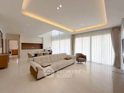 Spacious modern living room with elegant lighting and large windows