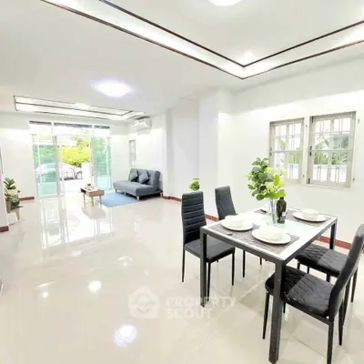 Spacious modern living room with dining area and large windows