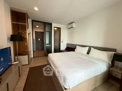 Modern bedroom with sleek design and cozy ambiance, featuring a comfortable bed and stylish decor.