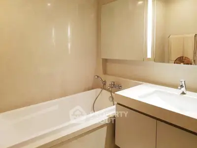 Modern bathroom with sleek bathtub and stylish vanity in elegant design.