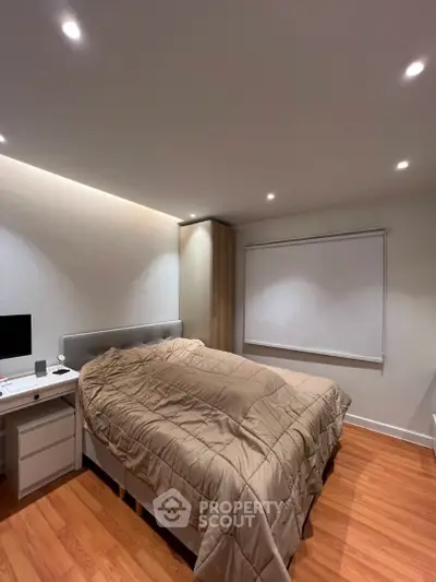 Modern bedroom with cozy lighting and sleek wooden flooring