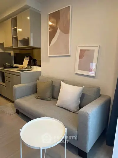 Chic modern living room with cozy sofa and stylish kitchen area, perfect for urban living.