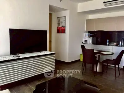 Modern living room with sleek furniture and open kitchen layout