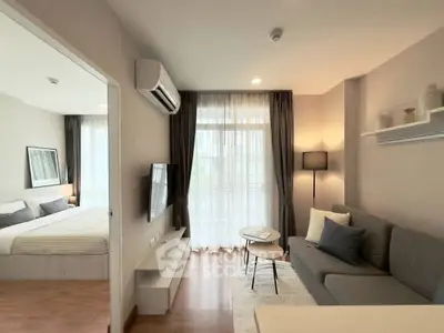 Modern living room with cozy sofa, TV, and large window in stylish apartment
