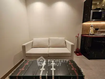 Modern living room with stylish sofa and sleek kitchen area