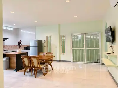 Spacious open-plan kitchen and dining area with modern appliances and stylish decor.