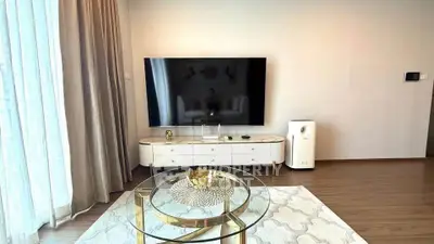 Modern living room with sleek TV setup and elegant glass coffee table