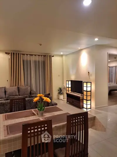 Spacious living room with elegant decor and cozy seating area, perfect for relaxation and entertainment.