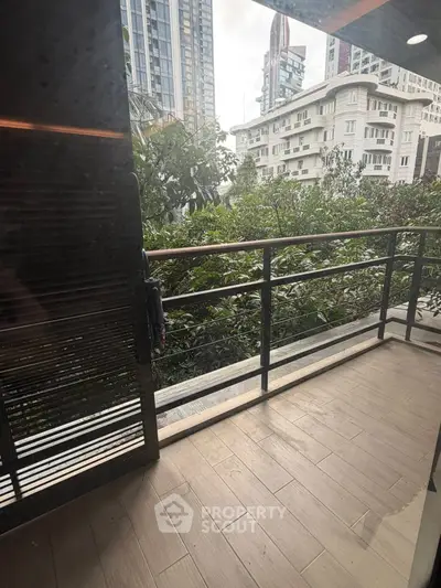 Spacious balcony with city view, perfect for relaxation and enjoying urban greenery.