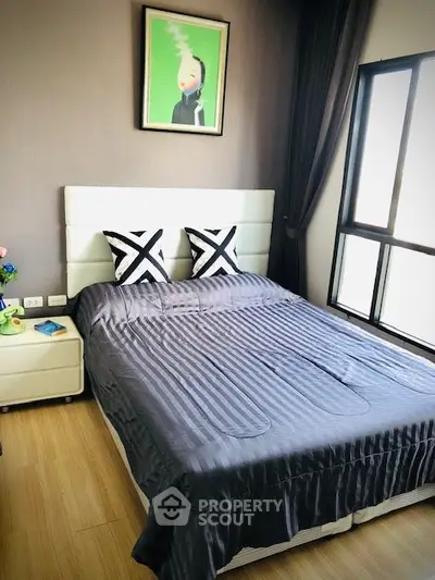 Cozy bedroom with modern decor and large window for natural light