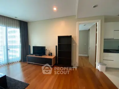 Spacious modern living room with hardwood floors and natural light