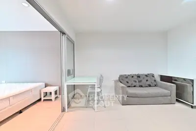 Modern living room with sliding glass doors and cozy furniture in a stylish apartment.