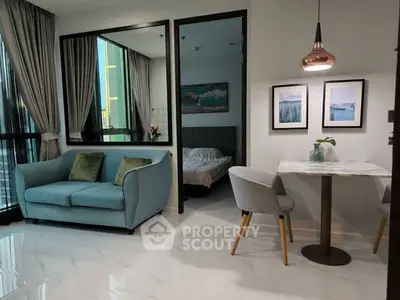 Modern apartment interior with cozy living area and stylish dining space.