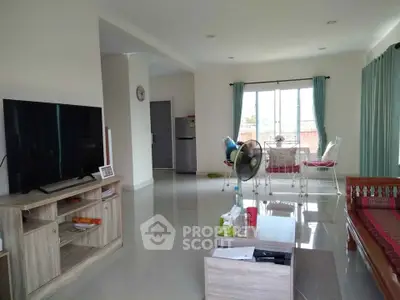 Spacious living room with modern decor and large windows for natural light.