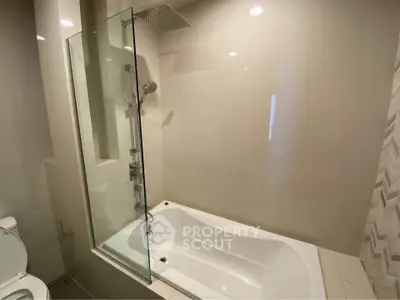 Modern bathroom with sleek bathtub and glass shower partition