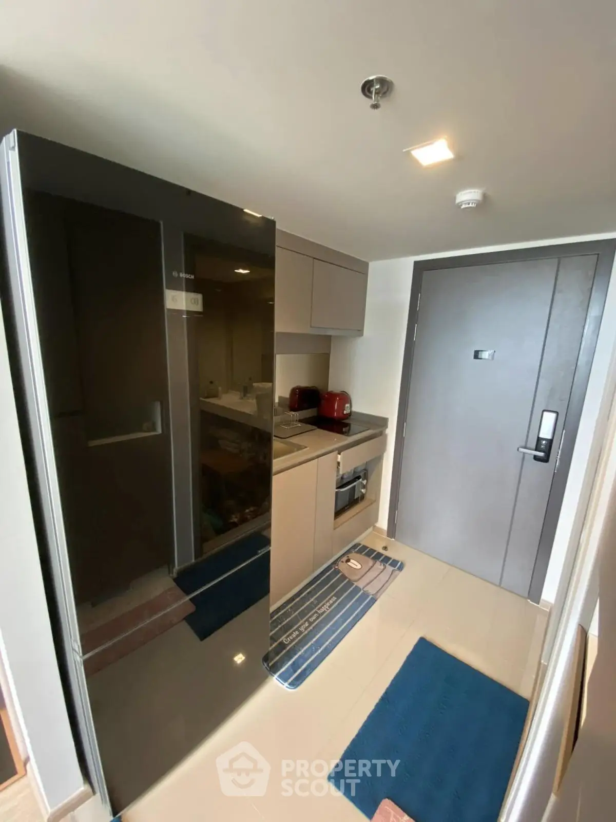 Modern compact kitchen with sleek appliances and stylish cabinetry