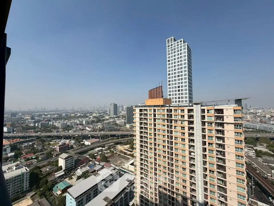 Stunning cityscape view from high-rise apartment balcony showcasing urban skyline and modern architecture.