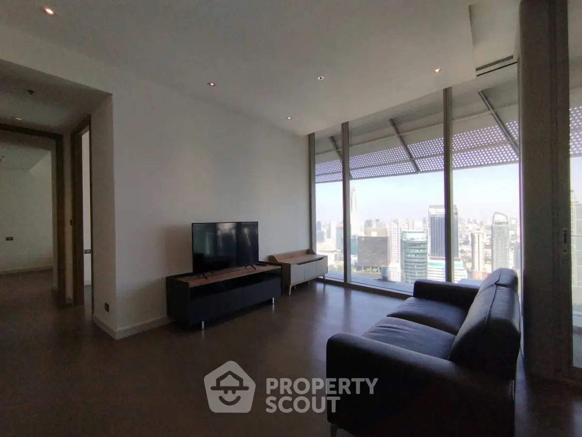 Spacious modern living room with stunning city view and sleek furnishings.