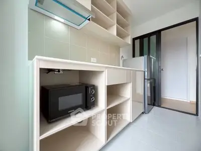 Modern kitchen with sleek cabinetry and appliances in a compact layout