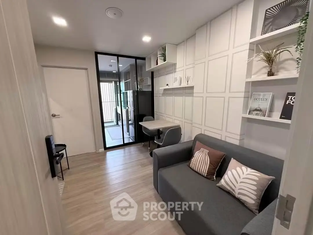 Modern living room with stylish decor and cozy seating in a contemporary apartment.