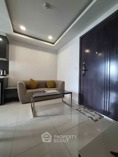 Modern living room with sleek sofa and stylish coffee table in a contemporary apartment.