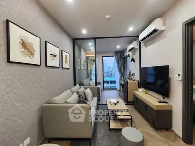 Modern living room with stylish decor and city view, featuring a cozy sofa and wall-mounted TV.