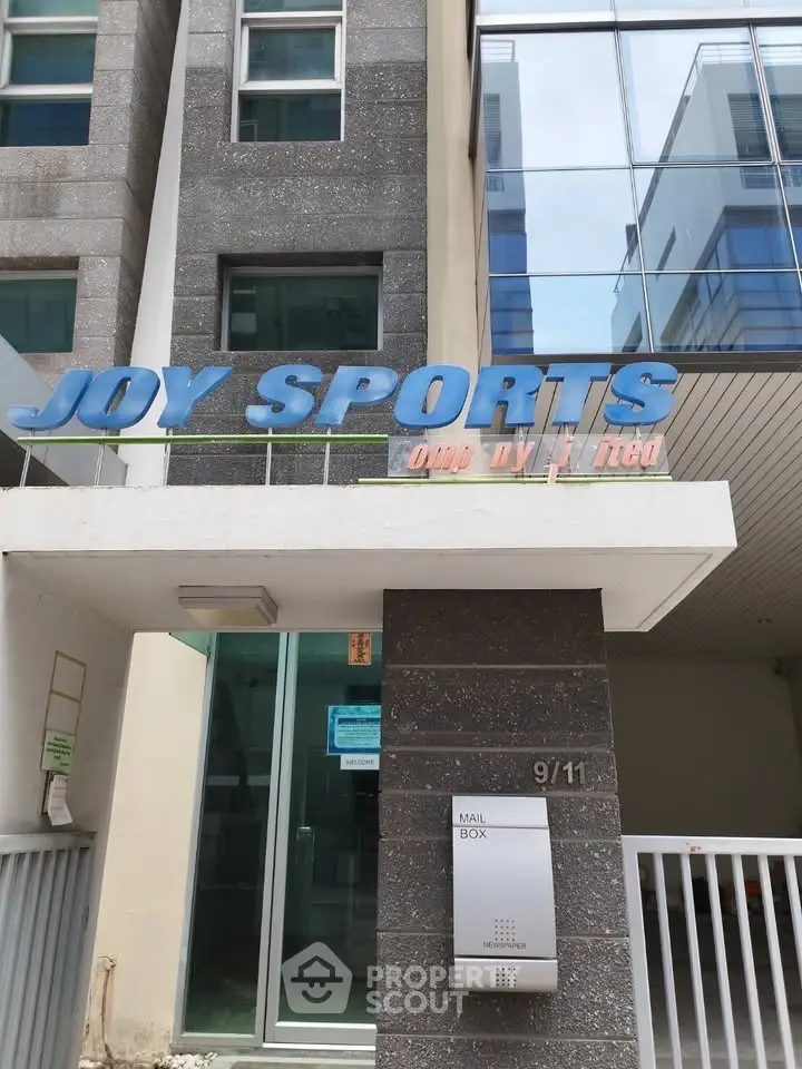 Modern building entrance with sleek mailbox and glass facade, ideal for commercial real estate investment.