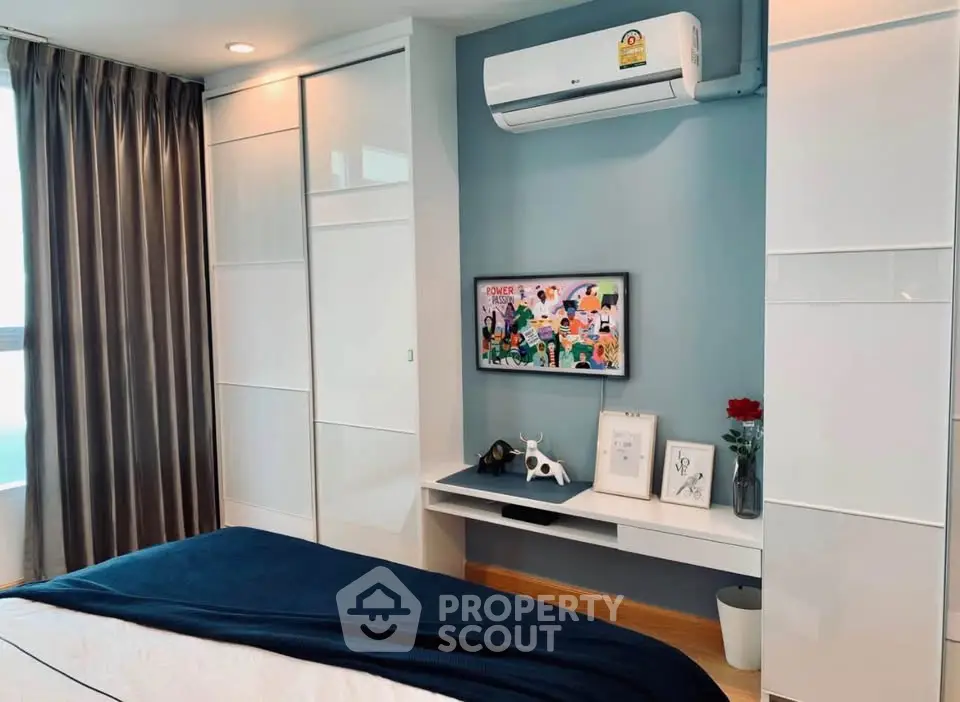 Modern bedroom with sleek design, featuring built-in wardrobe and air conditioning for ultimate comfort.