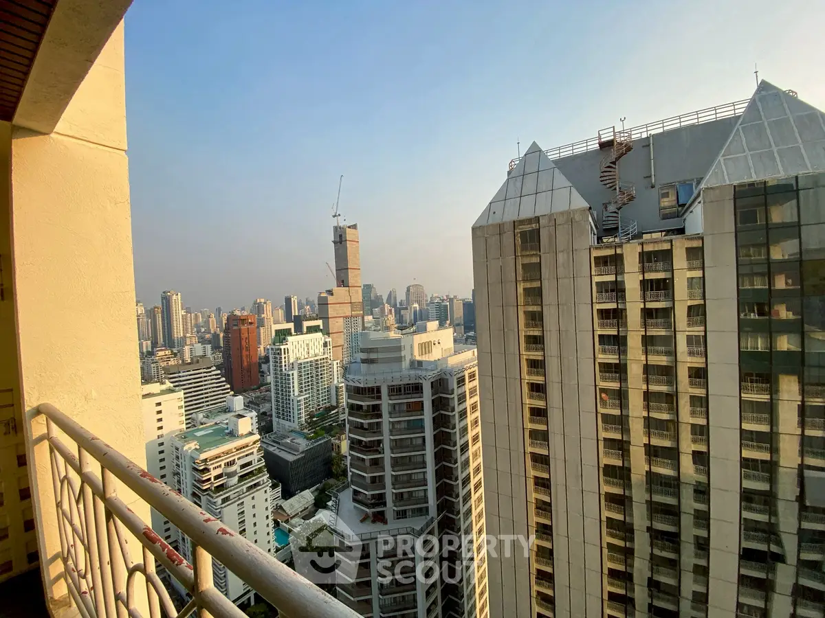 Stunning cityscape view from high-rise balcony in urban residential area.