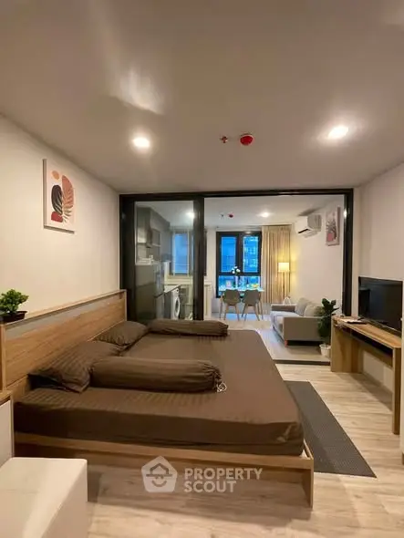 Modern studio apartment with open layout, featuring a cozy living area, kitchen, and stylish decor.
