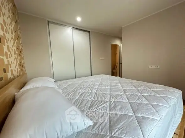 Cozy bedroom with modern decor and ample natural light