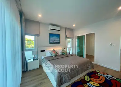 Spacious modern bedroom with stylish decor and natural light